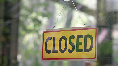 A sign reading closed in a window