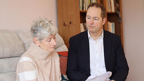 Richard Foord sat in a living room talking to a lady 