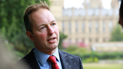 Richard Foord MP standing in front of parliament