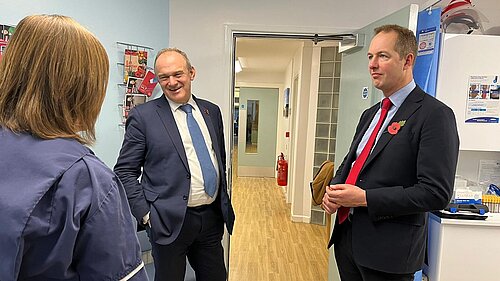 Richard Foord and Ed Davey talking to staff at a GP surgery