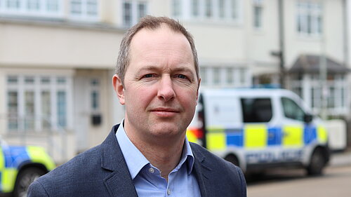 Richard Foord stood in front of a Police van