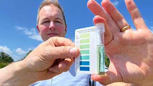 Richard Foord holding a water acidity tester