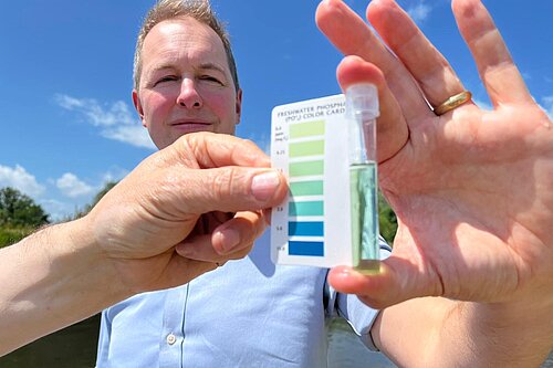 Richard Foord holding a water quality tester