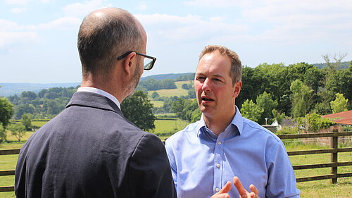 Richard Foord speaking to an interviewer in a field