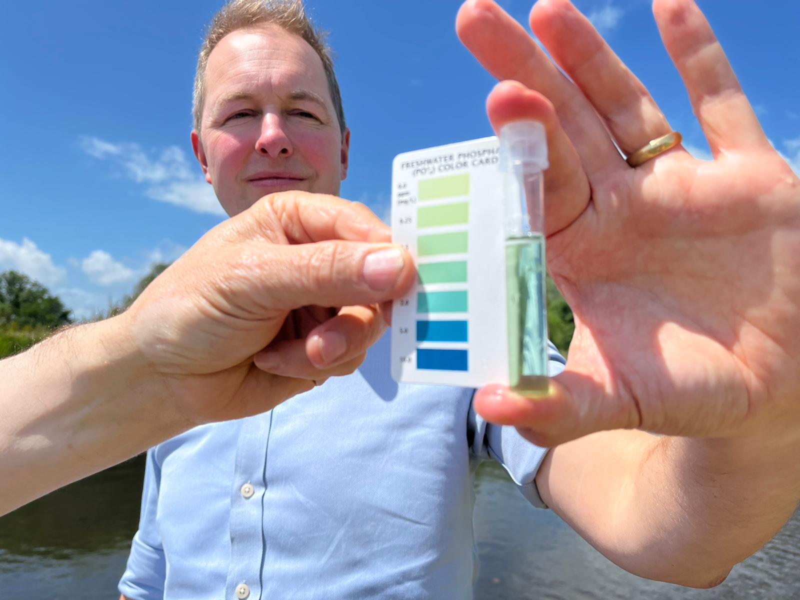 Richard Foord holding a water quality tester